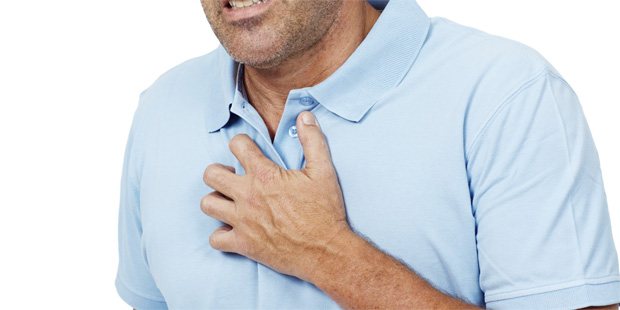 A man holds his chest with his hand